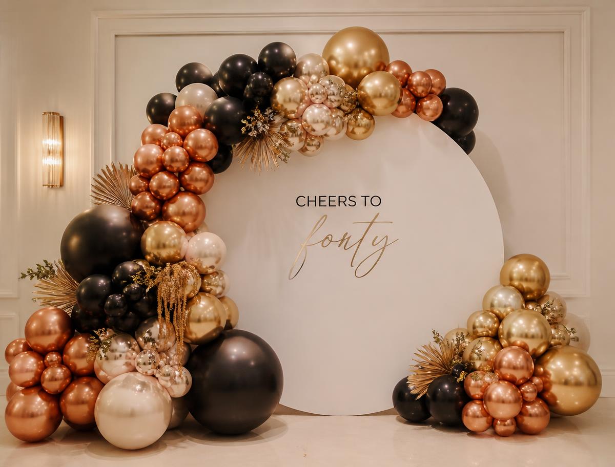Custom E3 balloon backdrop installation in black, copper and cream