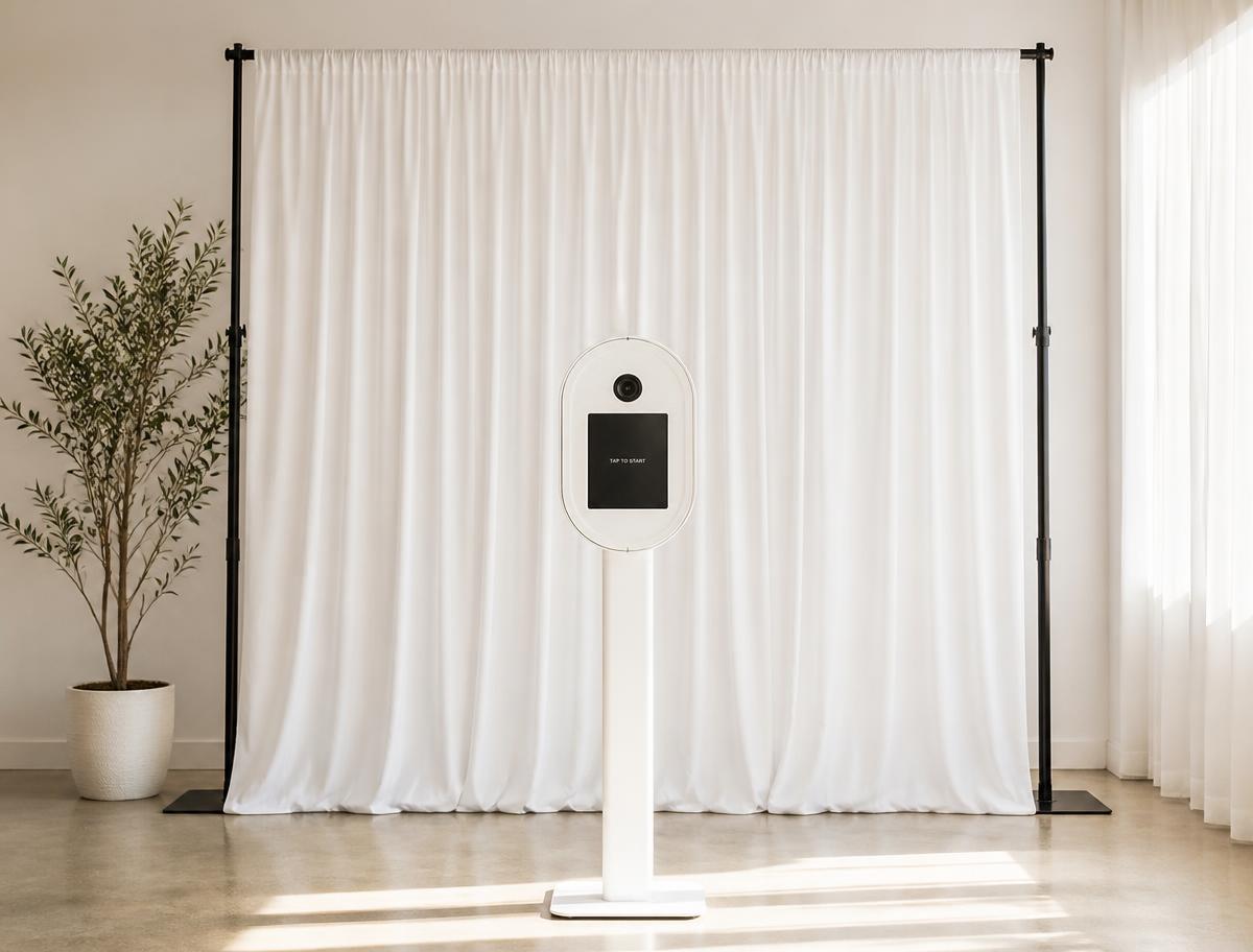 Simple plain photo booth backdrop with a Click & Capture booth in front of it